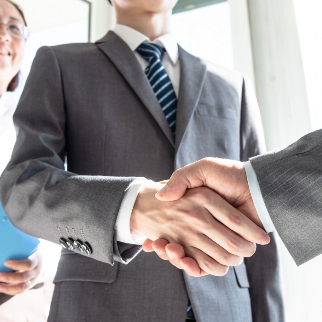 Picture of two business men shaking hands to represent the banking and financial services simulations site.